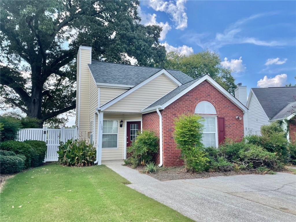 a front view of house with yard and green space