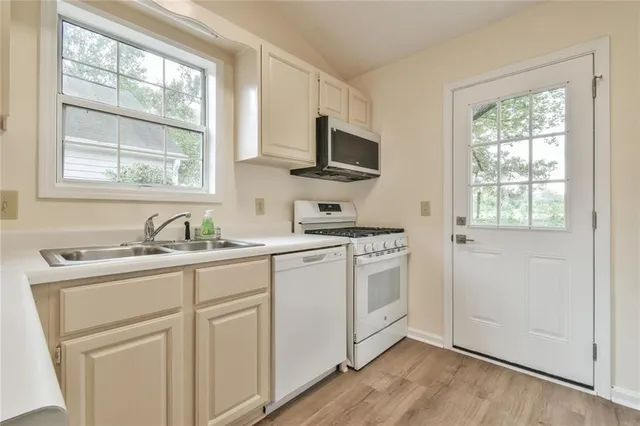 a kitchen with sink cabinets and window