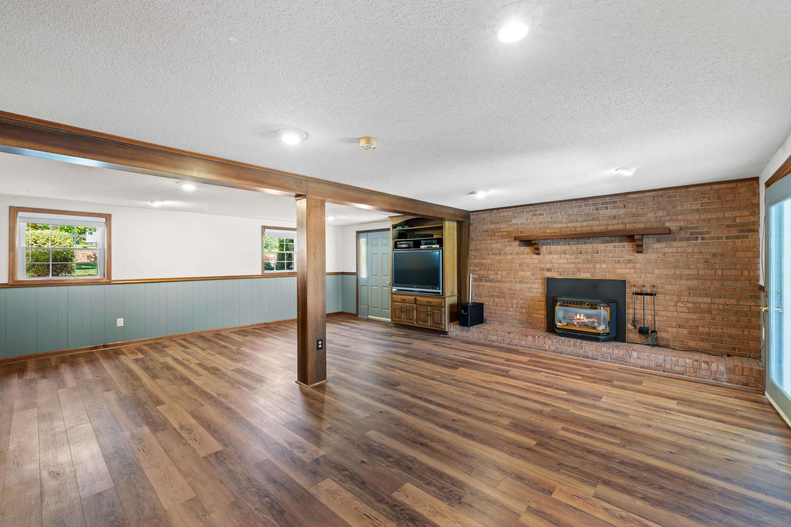 1569 Massanetta Springs Road Harrisonburg, VA 22801 - Photo 55 of 75 a view of an empty room with wooden floor fireplace and a window