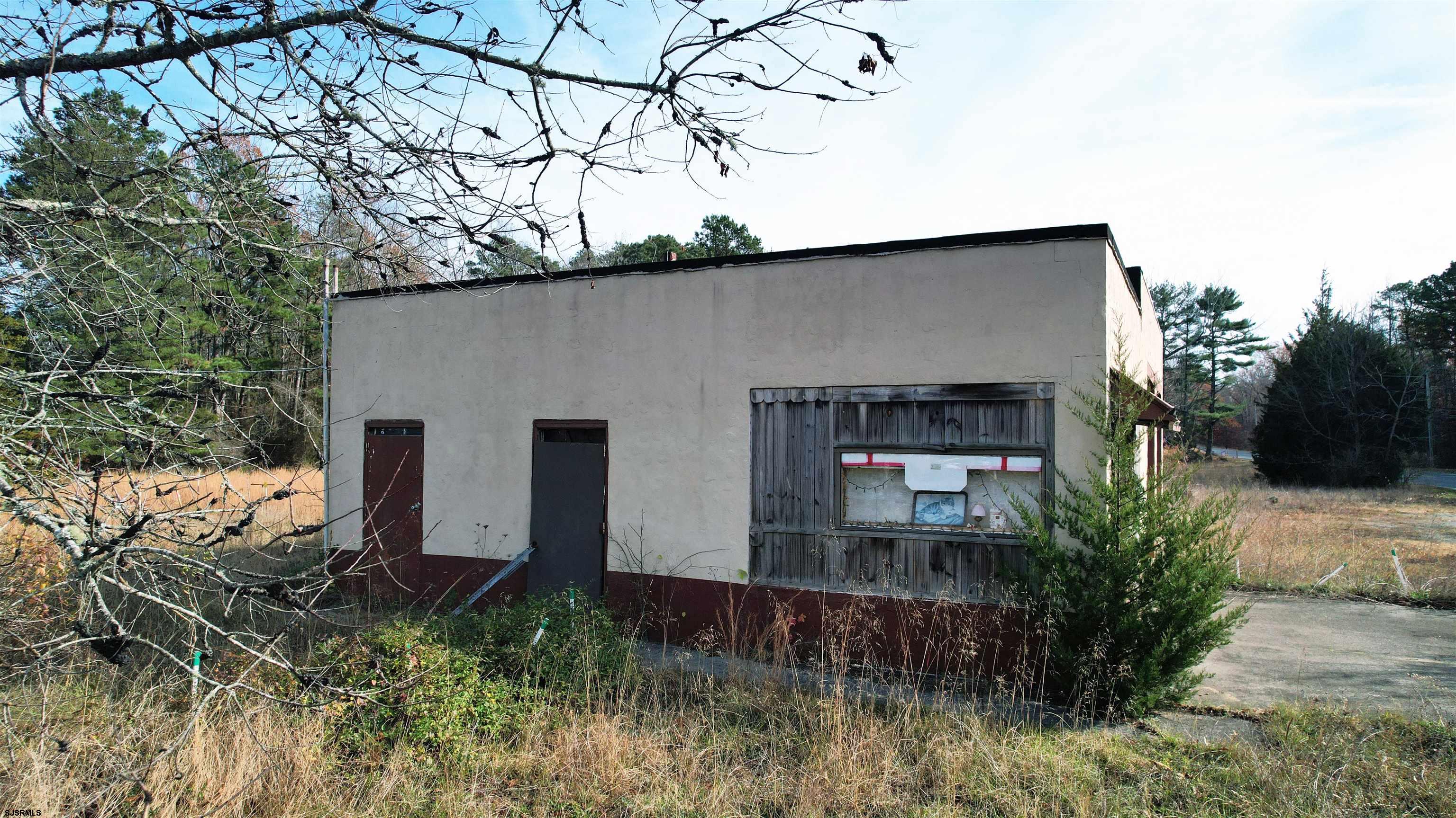 1105 Tuckahoe Road Milmay, NJ 08340 - Photo 17 of 20 a front view of house with yard and trees in the background