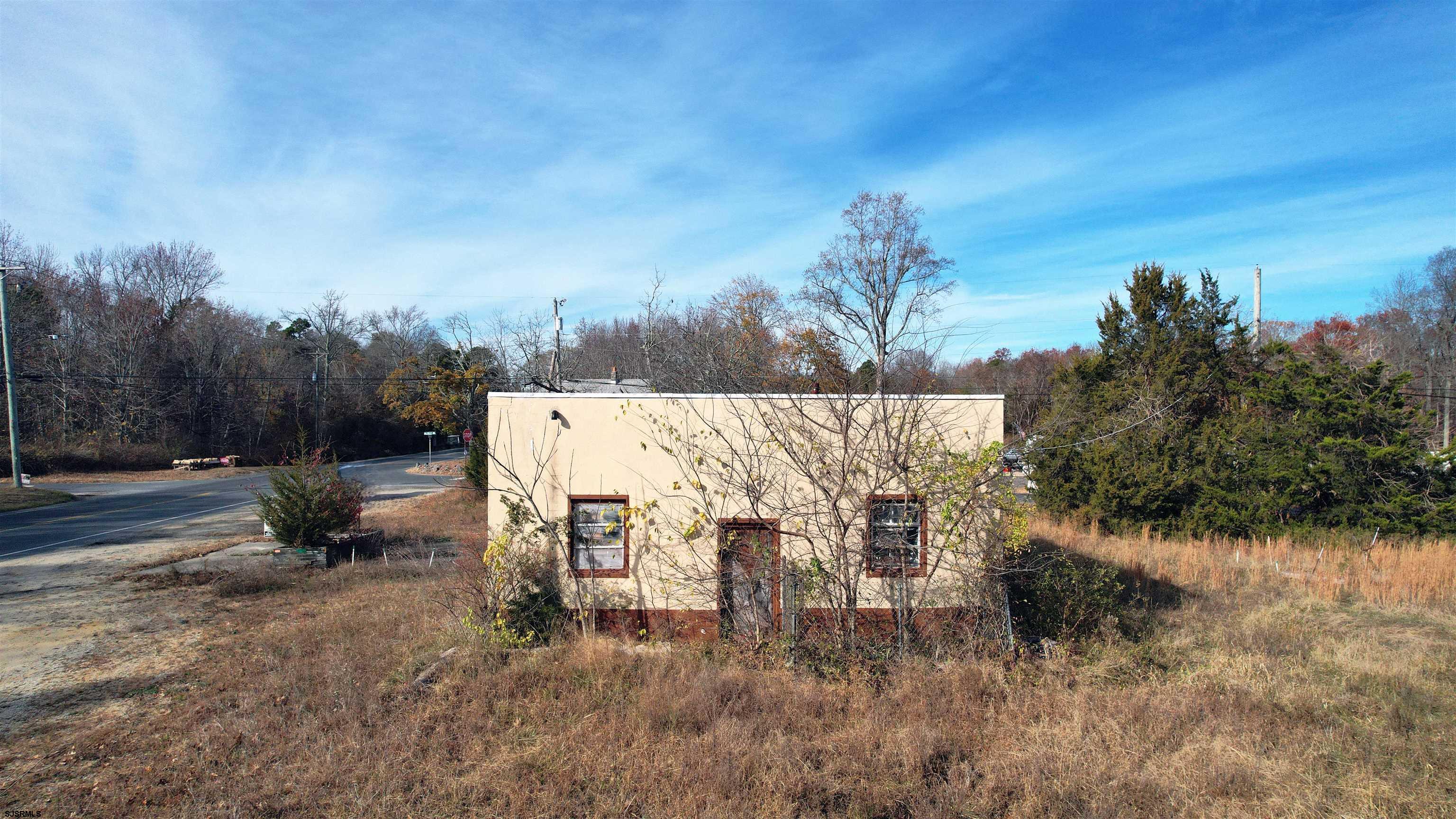 1105 Tuckahoe Road Milmay, NJ 08340 - Photo 9 of 20 a view of a terrace with a bench and trees around