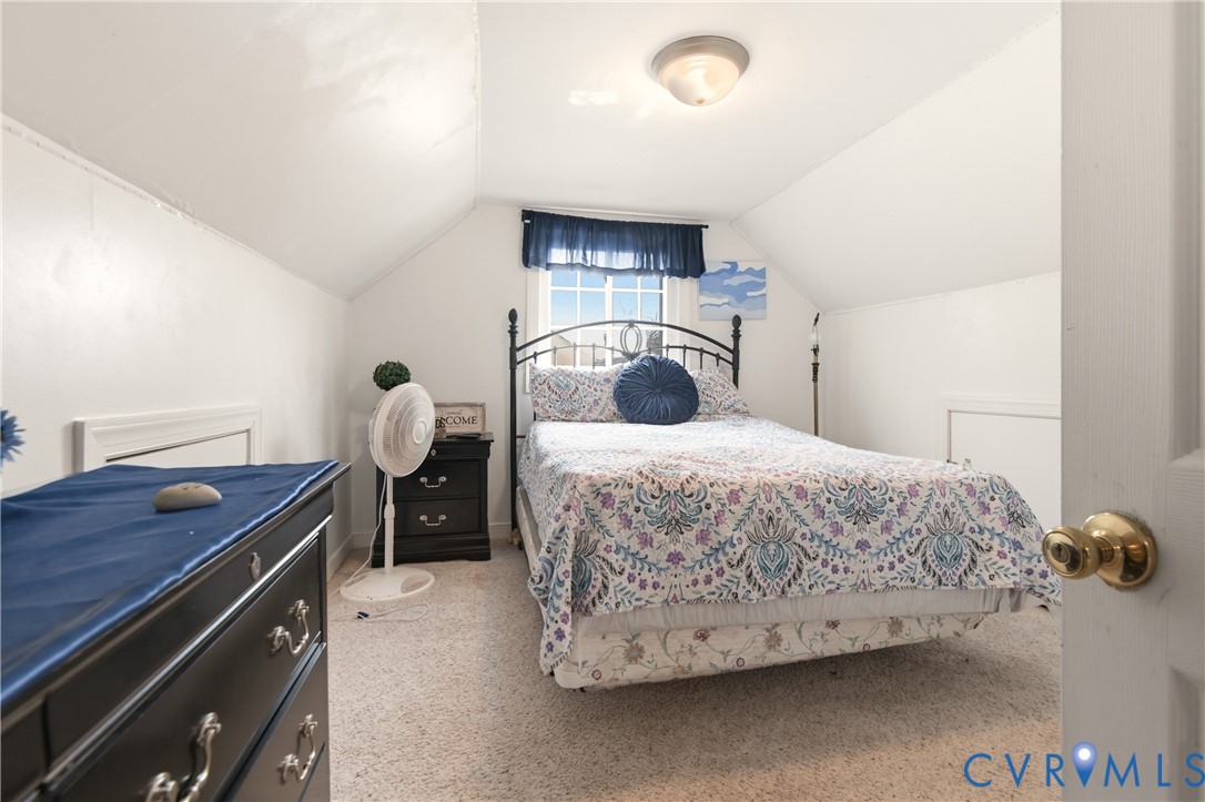 1311 Williamsburg Road Richmond, VA 23231 - Photo 29 of 38 Carpeted room with sloped ceilings and a window fe