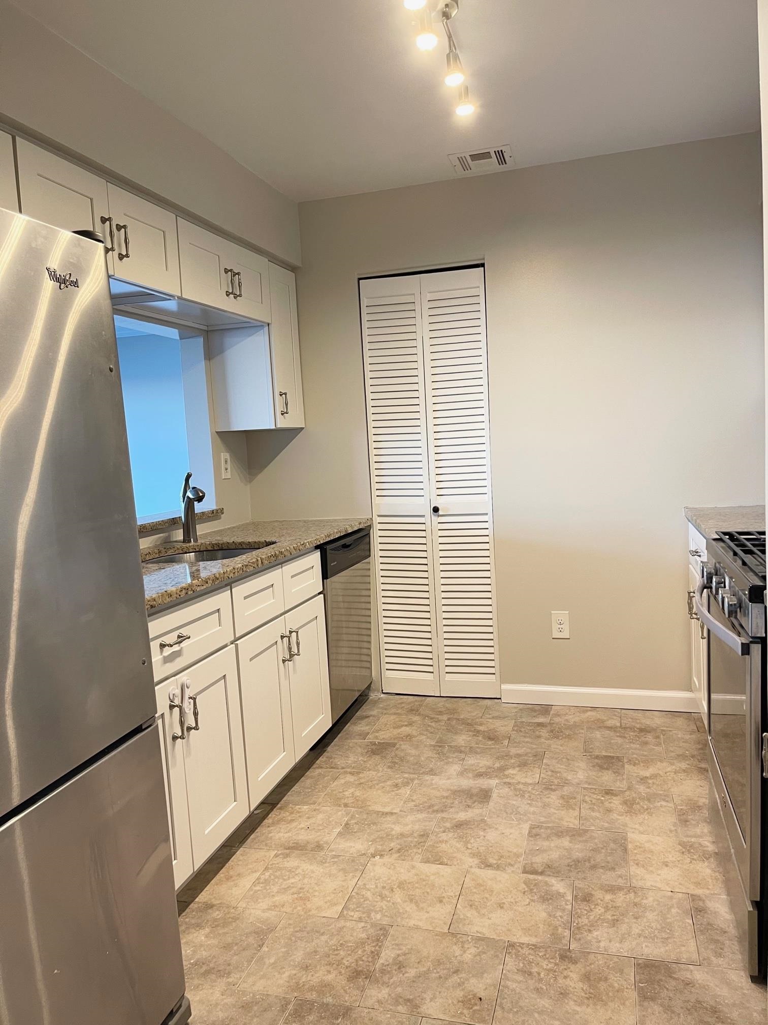 26 Bergen Ridge Road, Unit 2 North Bergen, NJ 07047 - Photo 3 of 9 a kitchen with granite countertop a sink a stove a refrigerator and cabinets