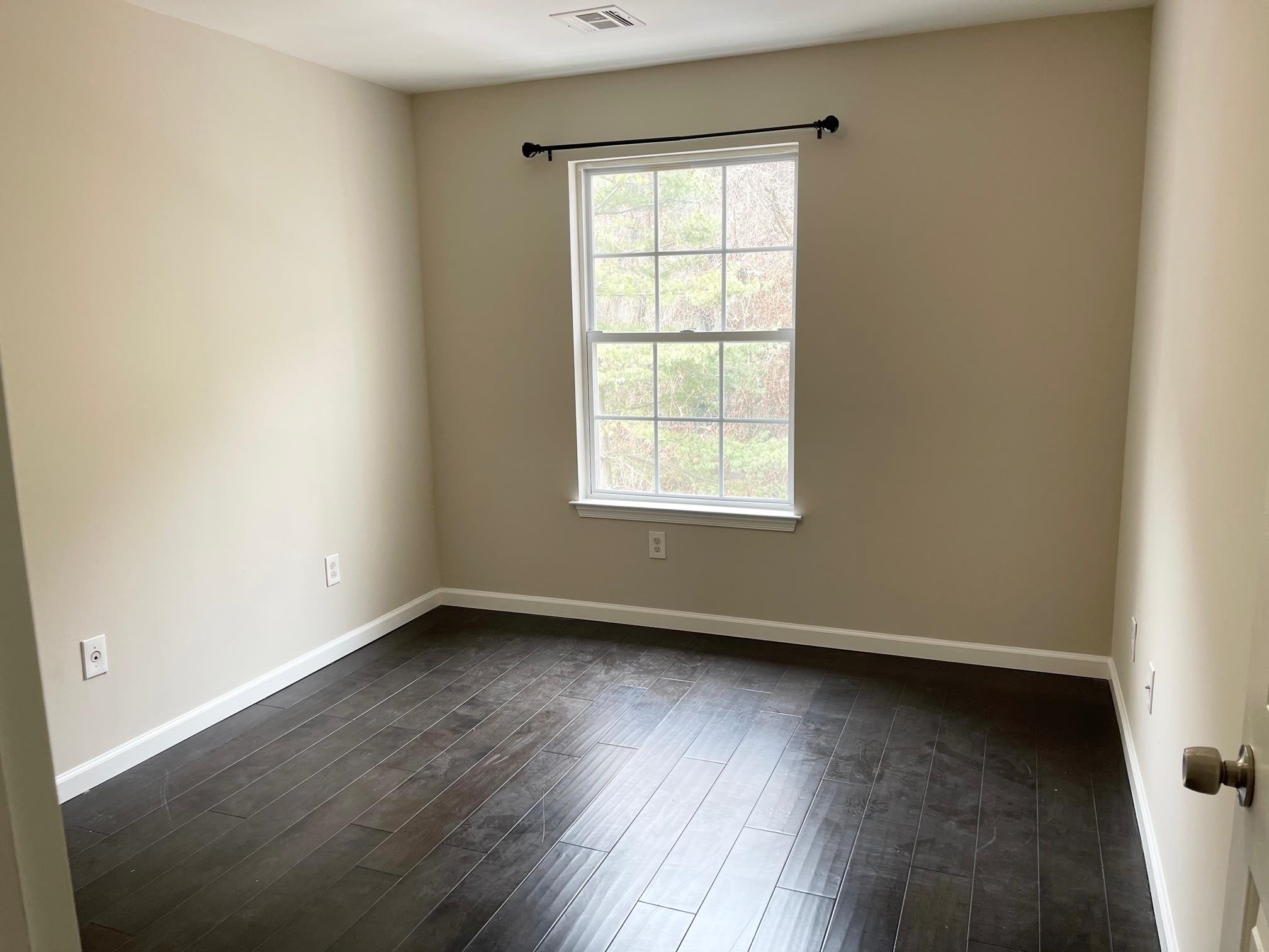 26 Bergen Ridge Road, Unit 2 North Bergen, NJ 07047 - Photo 5 of 9 an empty room with wooden floor and windows
