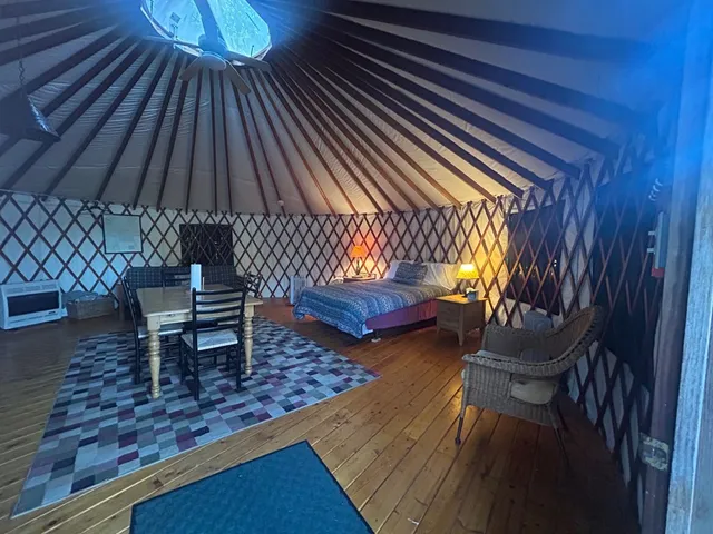 a view of a roof deck with wooden floor and a fire pit