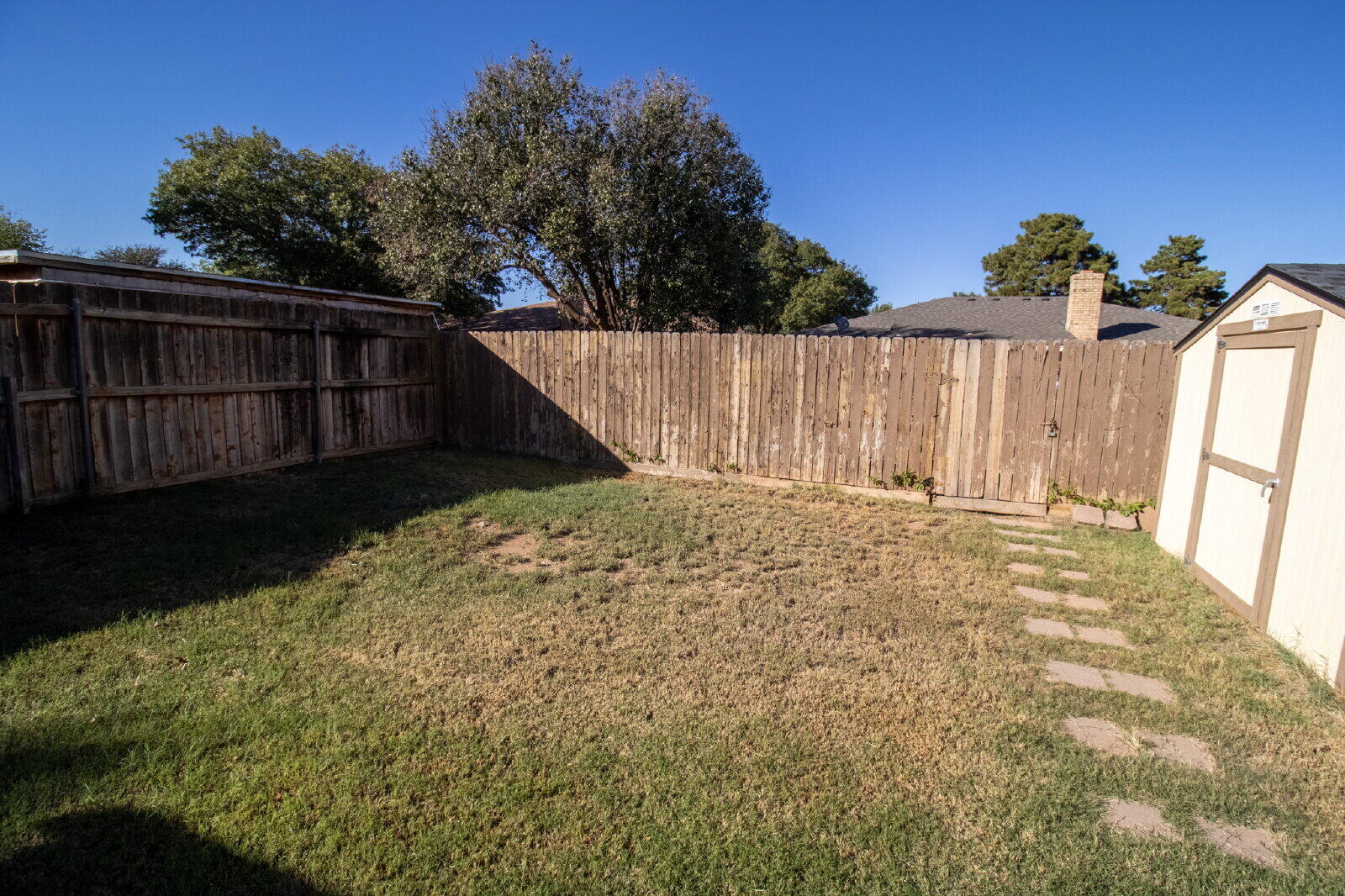 5718 90th Street Lubbock, TX 79424 - Photo 13 of 15 a view of wooden fence and a yard