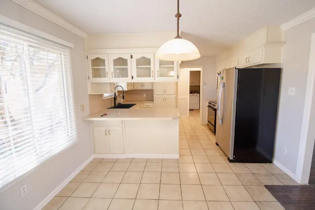 a kitchen with stainless steel appliances a refrigerator and a stove top oven