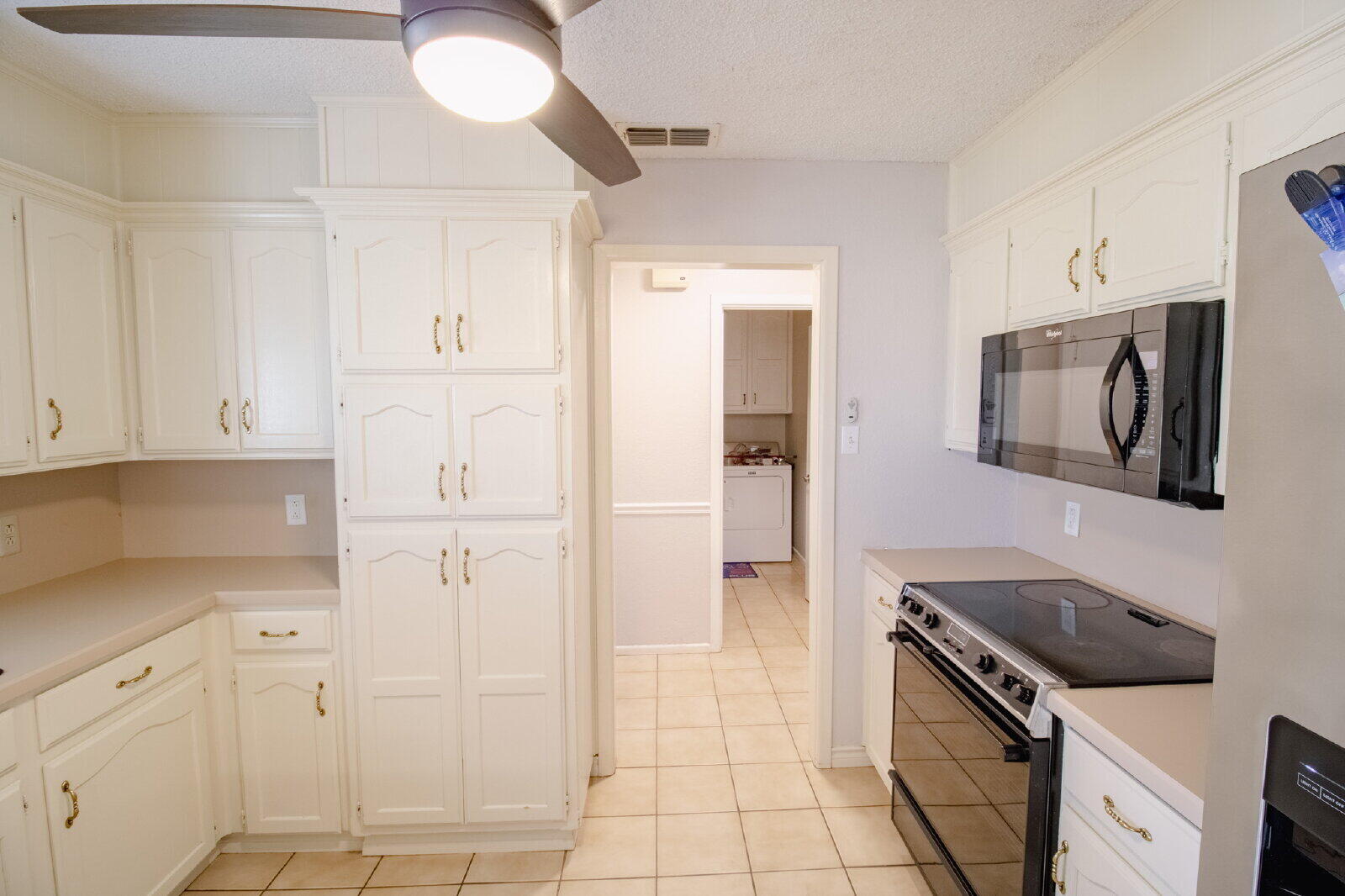 5718 90th Street Lubbock, TX 79424 - Photo 5 of 15 a kitchen with cabinets and a stove