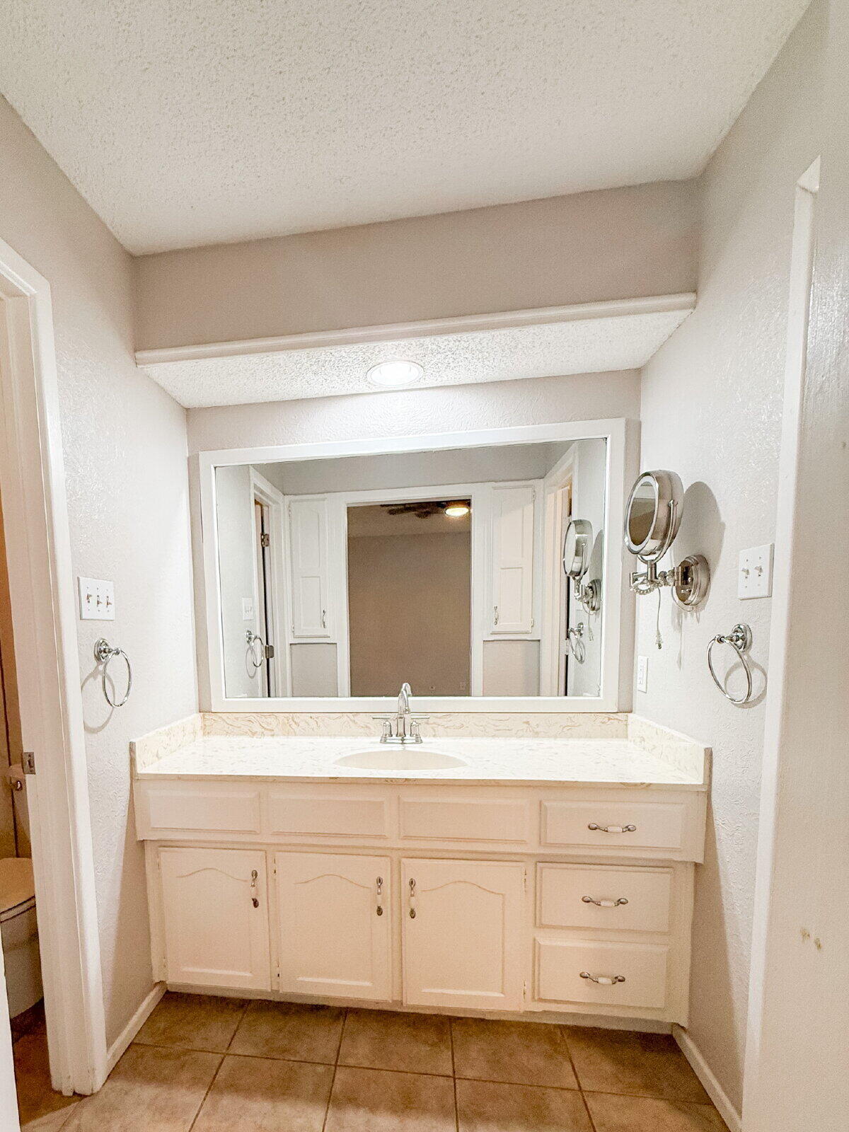 5718 90th Street Lubbock, TX 79424 - Photo 8 of 15 a bathroom with a sink vanity and mirror