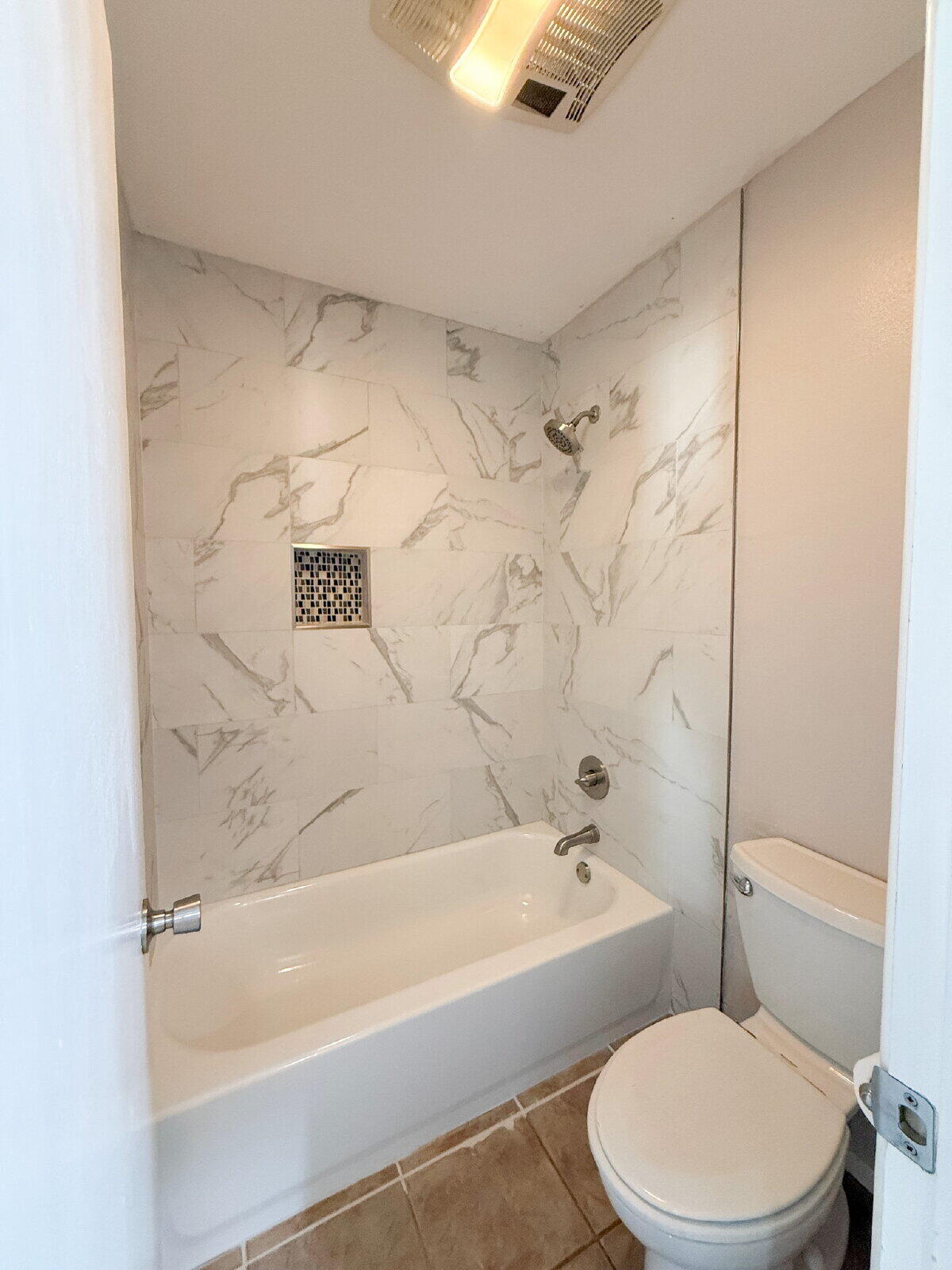 5718 90th Street Lubbock, TX 79424 - Photo 9 of 15 a bathroom with a toilet and a bath tub