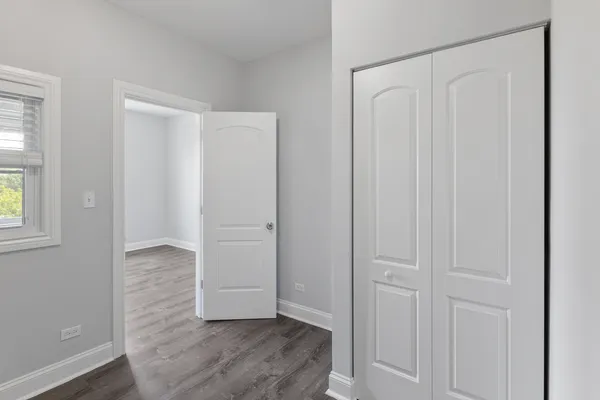an empty room with closet area