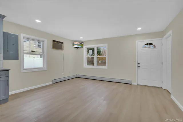 an empty room with windows and closet