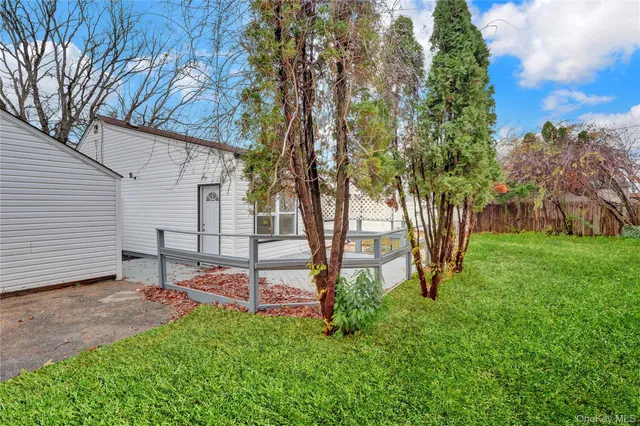 a view of a backyard with wooden fence