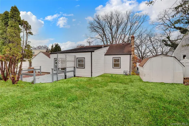 a view of a house with a yard and a garden