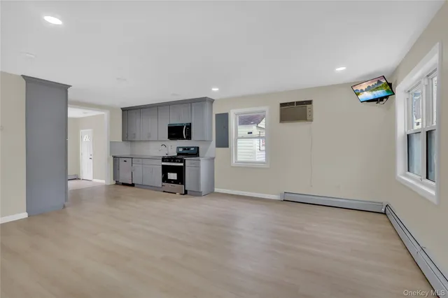 a view of open kitchen with a sink refrigerator and window