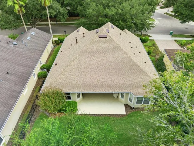 a view of a house with a yard and sitting area