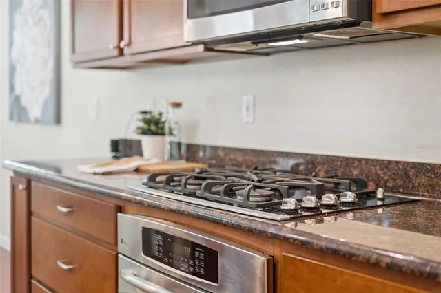 a stove top oven sitting inside of a kitchen