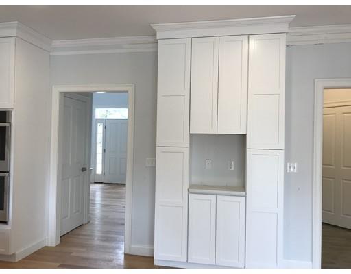 53 Wellesley Rd Extension Natick, MA 01760 - Photo 8 of 33 a view of a kitchen with white cabinets and wooden floor