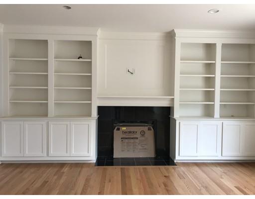53 Wellesley Rd Extension Natick, MA 01760 - Photo 10 of 33 a living room with a fireplace and wooden floor