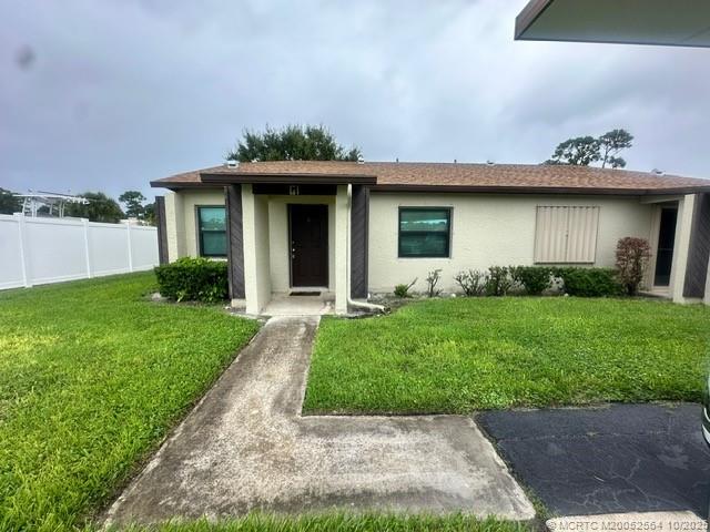 6022 Indrio Road, Unit G1 Fort Pierce, FL 34951 - Photo 4 of 23 a front view of a house with garden