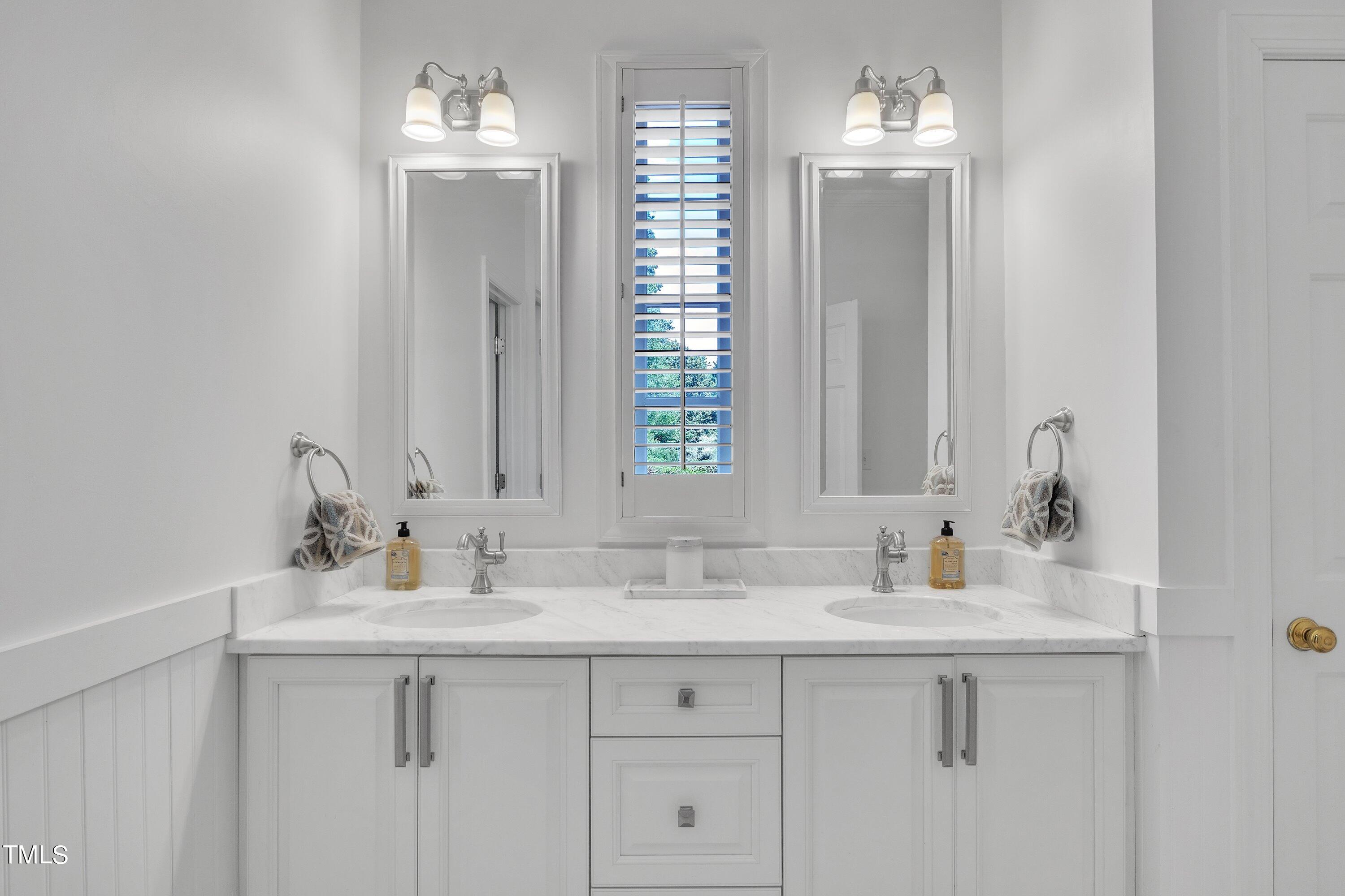 8500 Caldbeck Drive Raleigh, NC 27615 - Photo 11 of 37 a bathroom with double sink and a mirror
