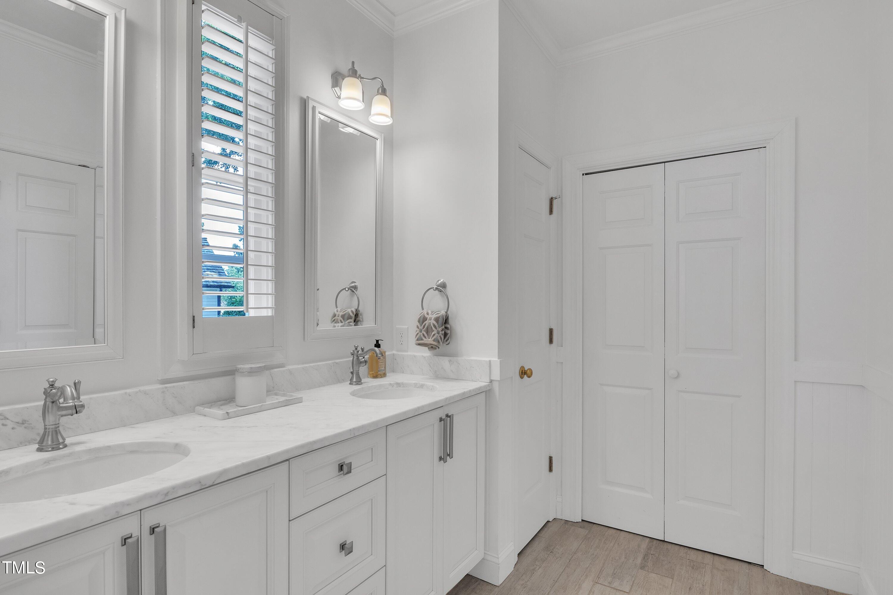 8500 Caldbeck Drive Raleigh, NC 27615 - Photo 12 of 37 a bathroom with double vanity sink a mirror and a shower