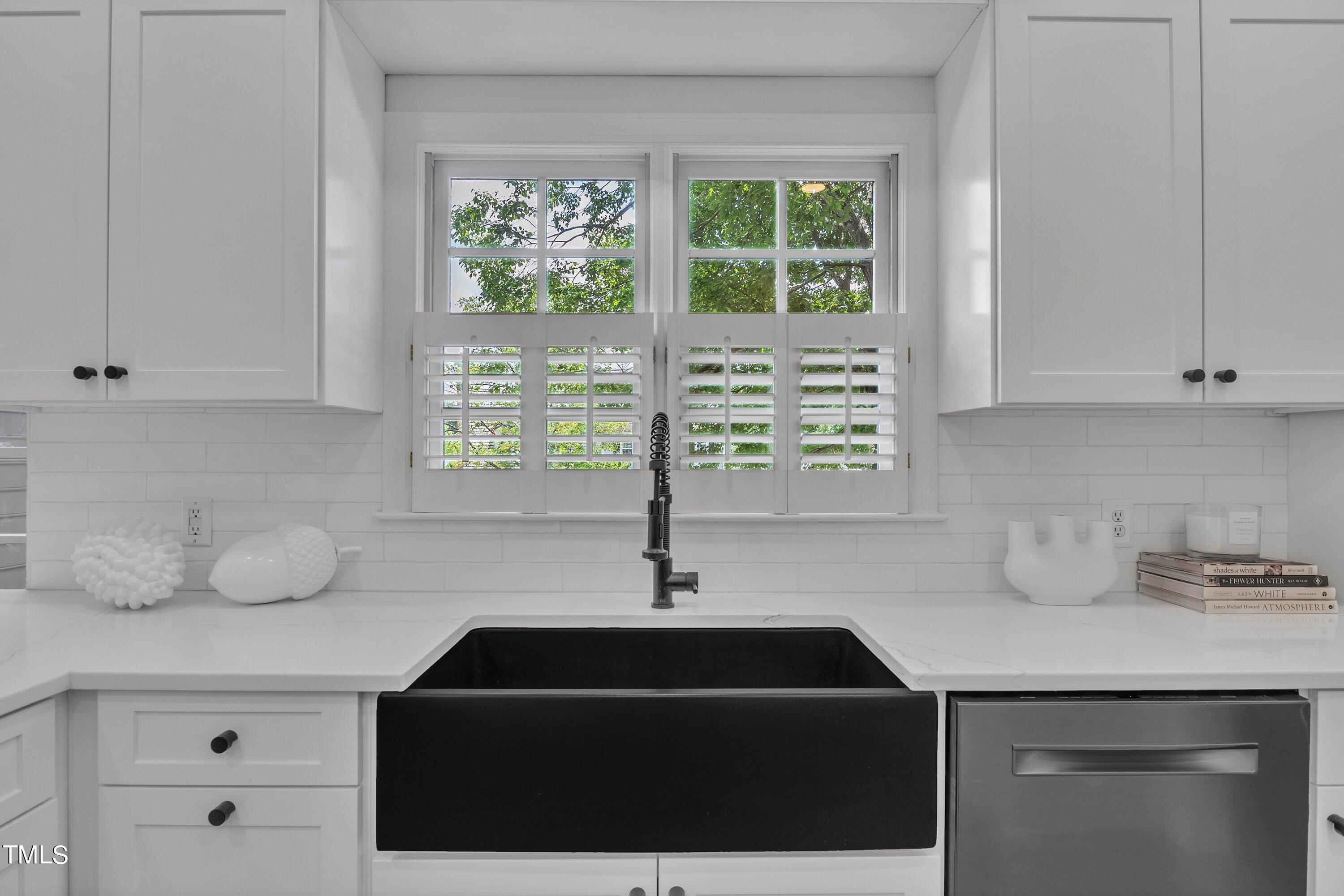 8500 Caldbeck Drive Raleigh, NC 27615 - Photo 18 of 37 a kitchen with a sink a window and cabinets