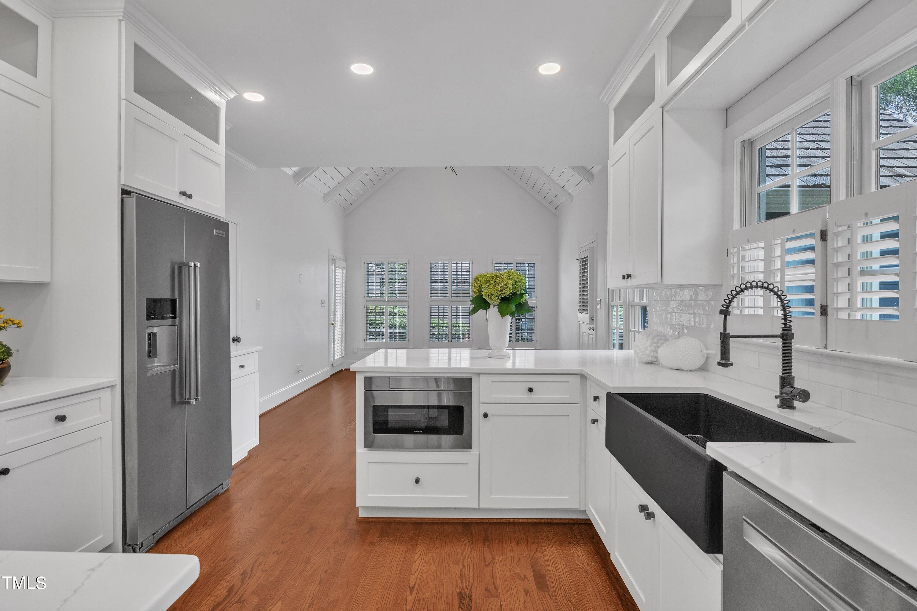 8500 Caldbeck Drive Raleigh, NC 27615 - Photo 19 of 37 a kitchen with stainless steel appliances a sink a stove a refrigerator and wooden floor