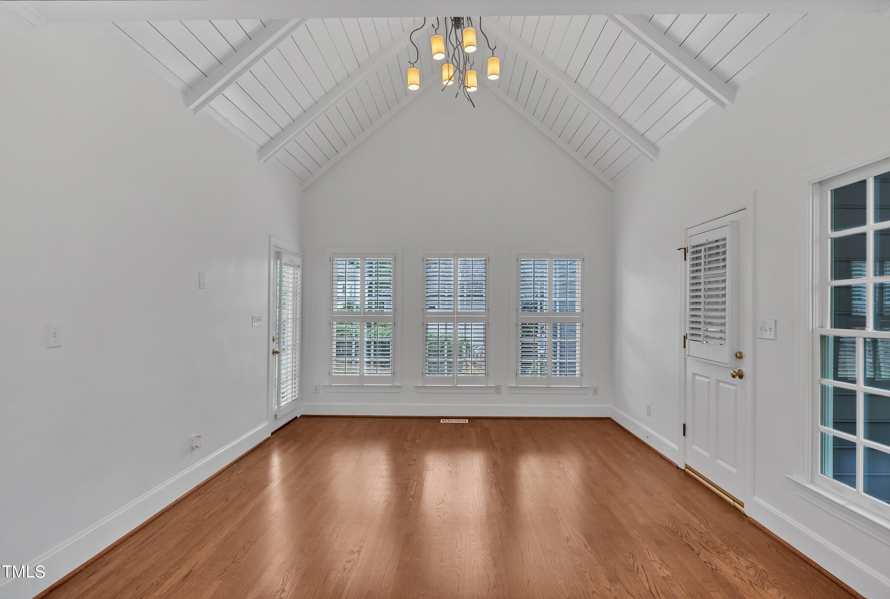 8500 Caldbeck Drive Raleigh, NC 27615 - Photo 20 of 37 an empty room with wooden floor and windows