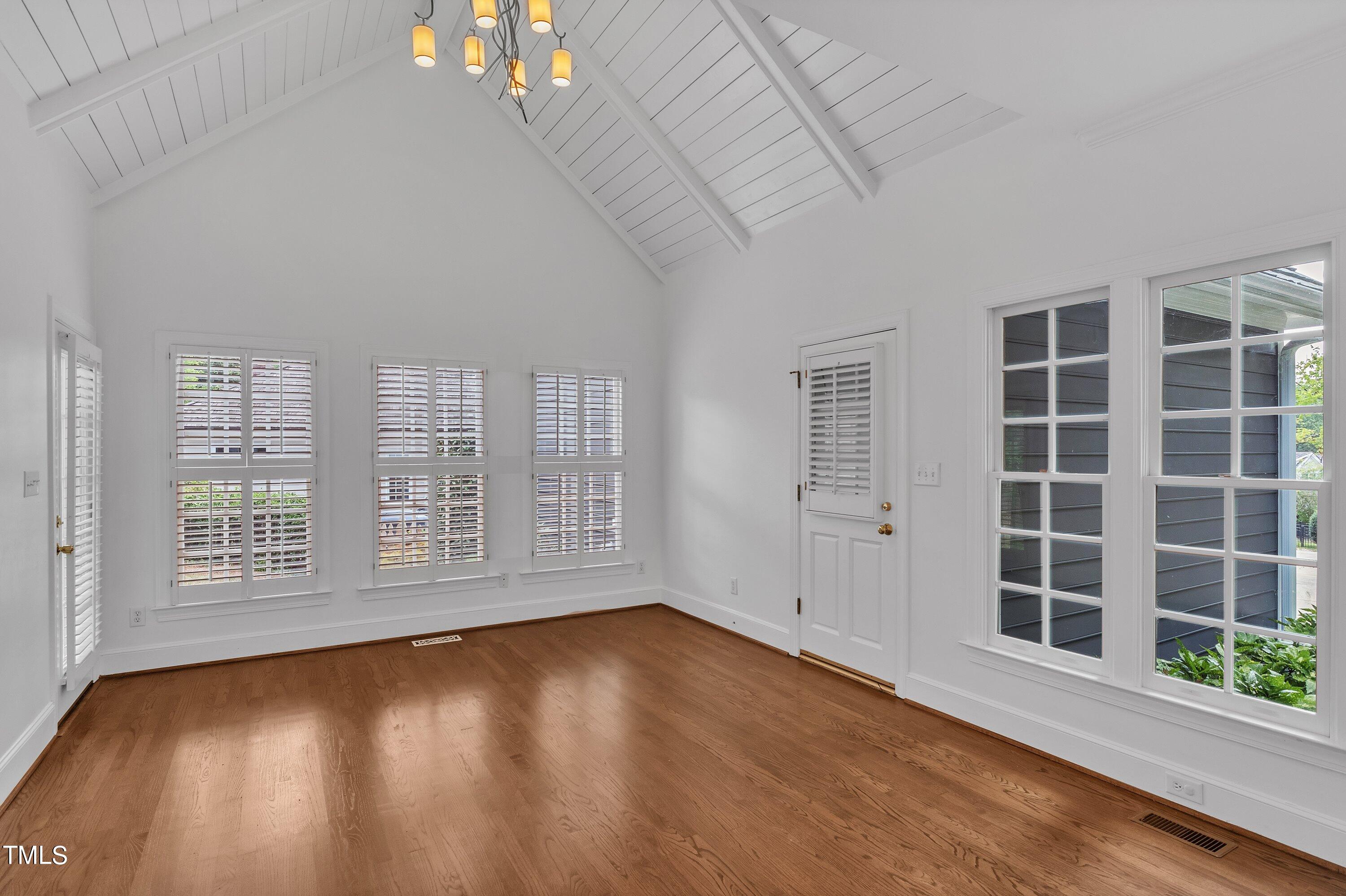 8500 Caldbeck Drive Raleigh, NC 27615 - Photo 21 of 37 a view of an empty room with a window and wooden floor