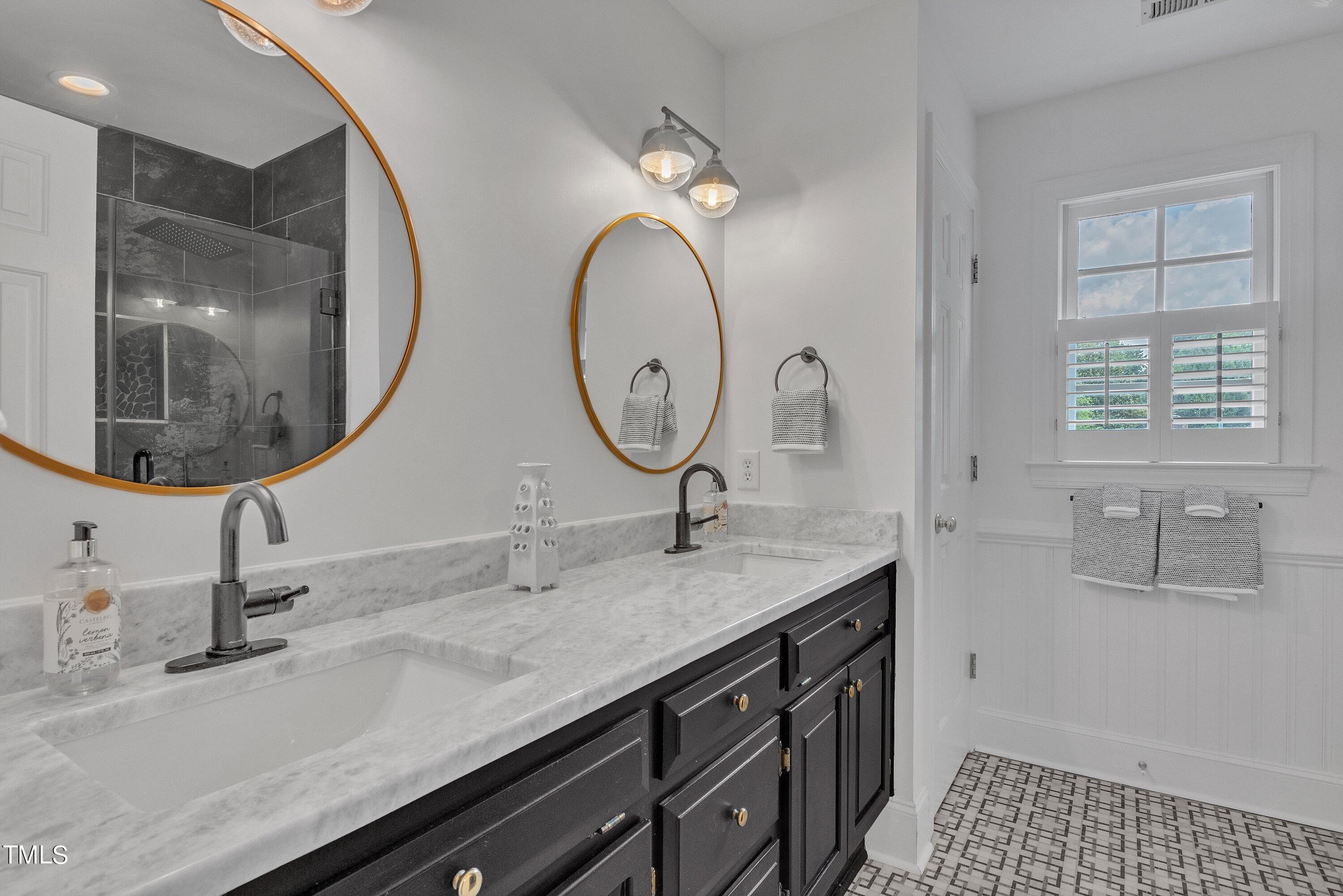 8500 Caldbeck Drive Raleigh, NC 27615 - Photo 27 of 37 a bathroom with a granite countertop double vanity sink and a mirror