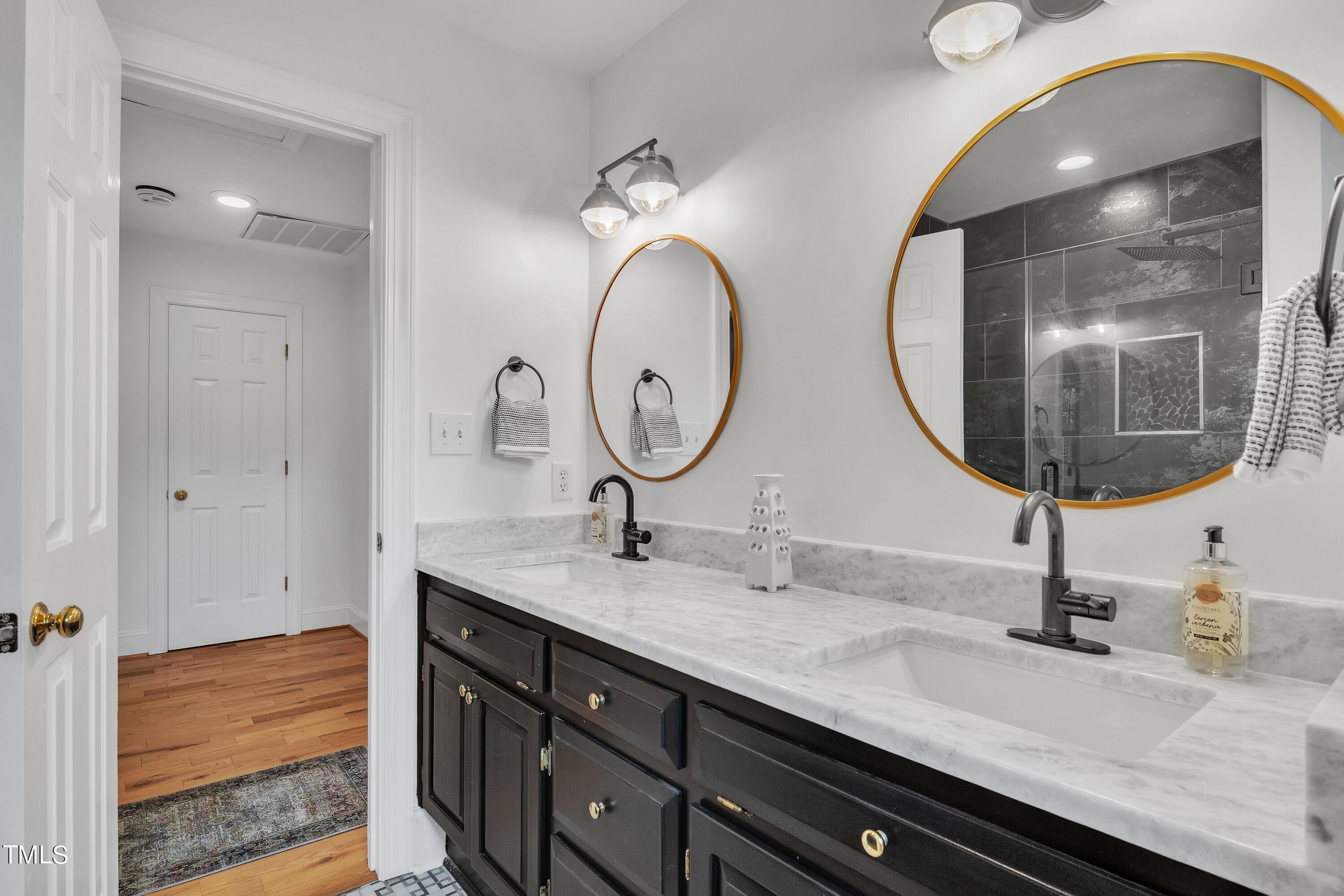 8500 Caldbeck Drive Raleigh, NC 27615 - Photo 28 of 37 a bathroom with a granite countertop double vanity sinks and a mirror