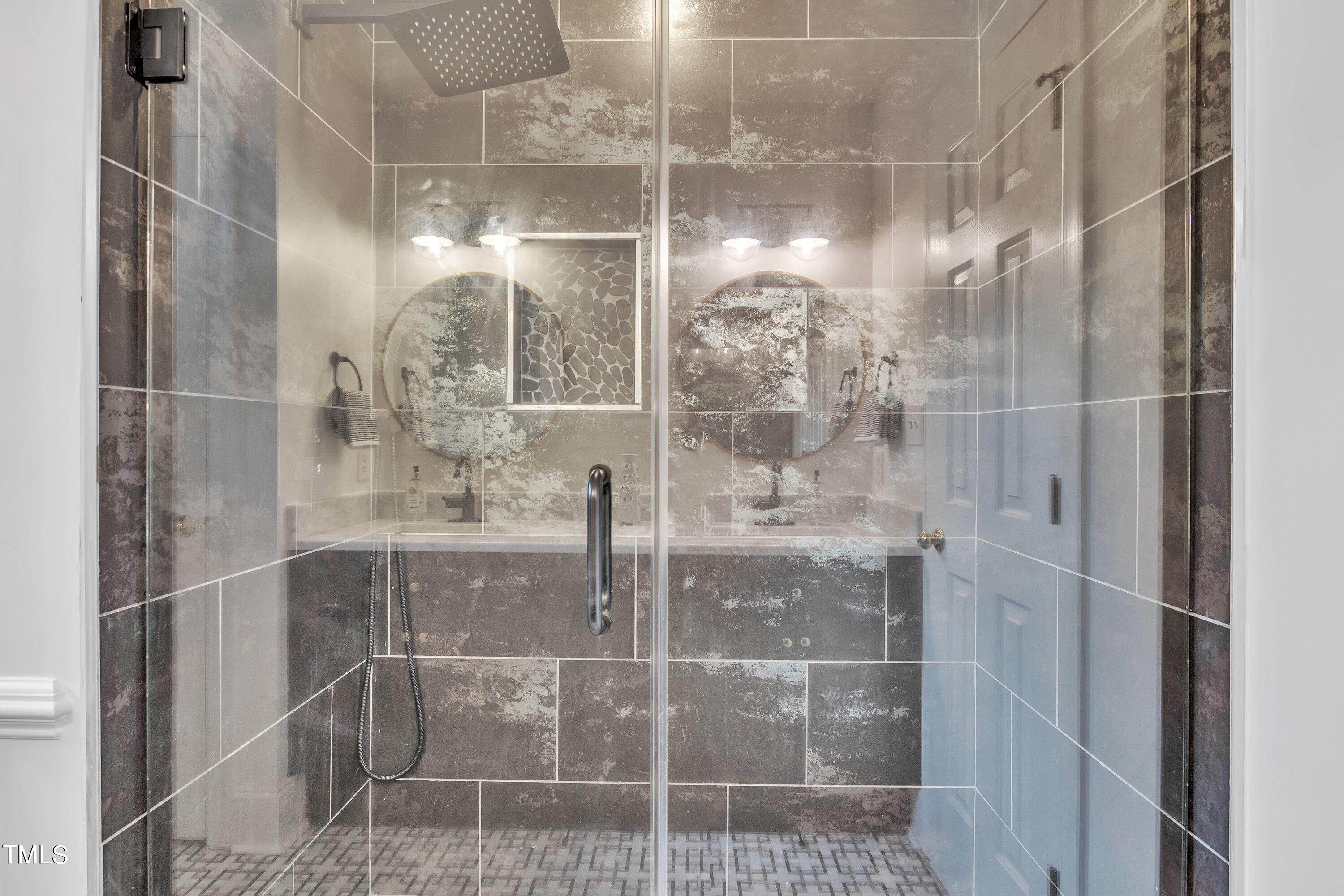 8500 Caldbeck Drive Raleigh, NC 27615 - Photo 29 of 37 a bathroom with a glass shower door