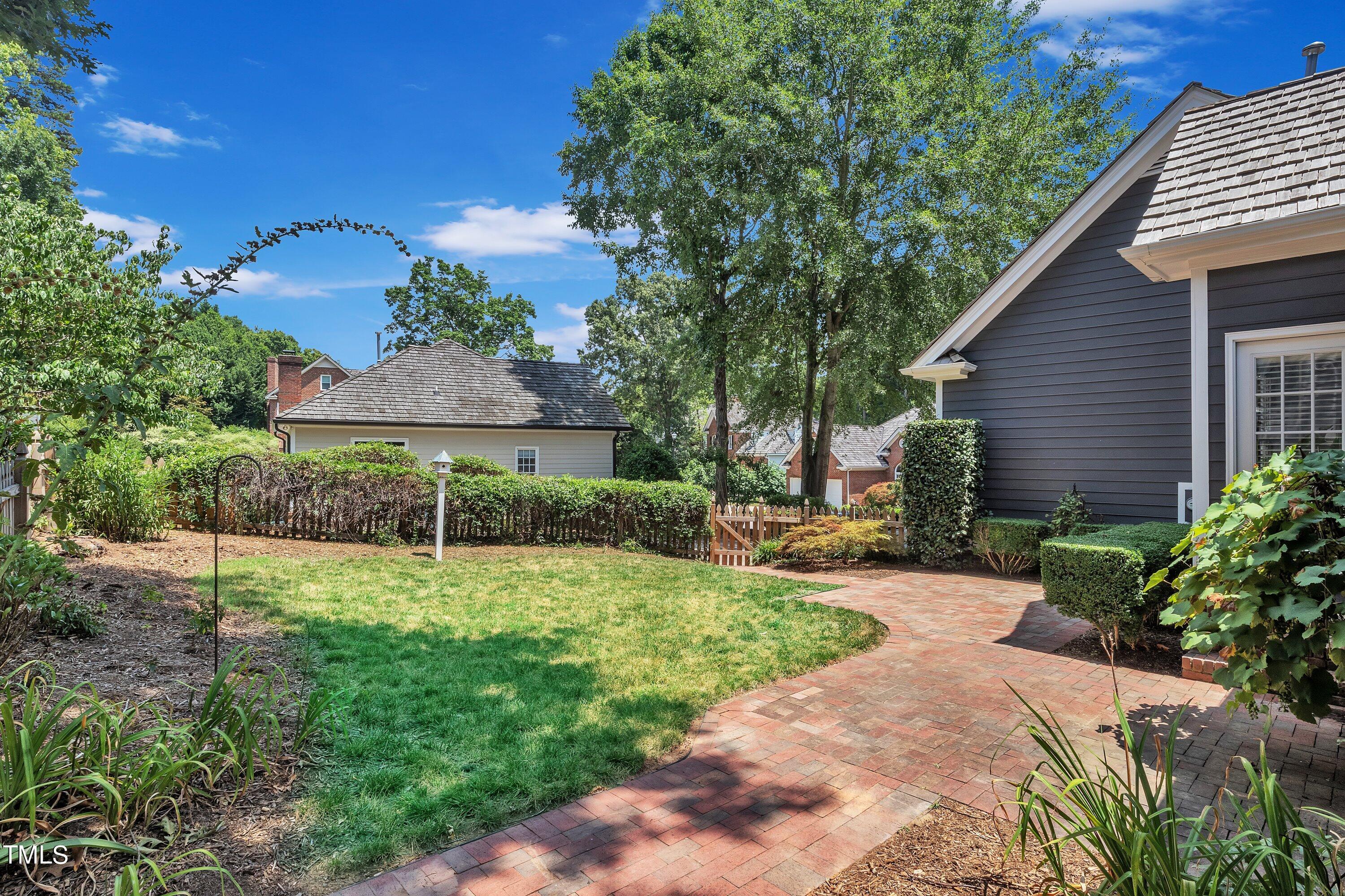8500 Caldbeck Drive Raleigh, NC 27615 - Photo 33 of 37 a view of a house with a yard and potted plants