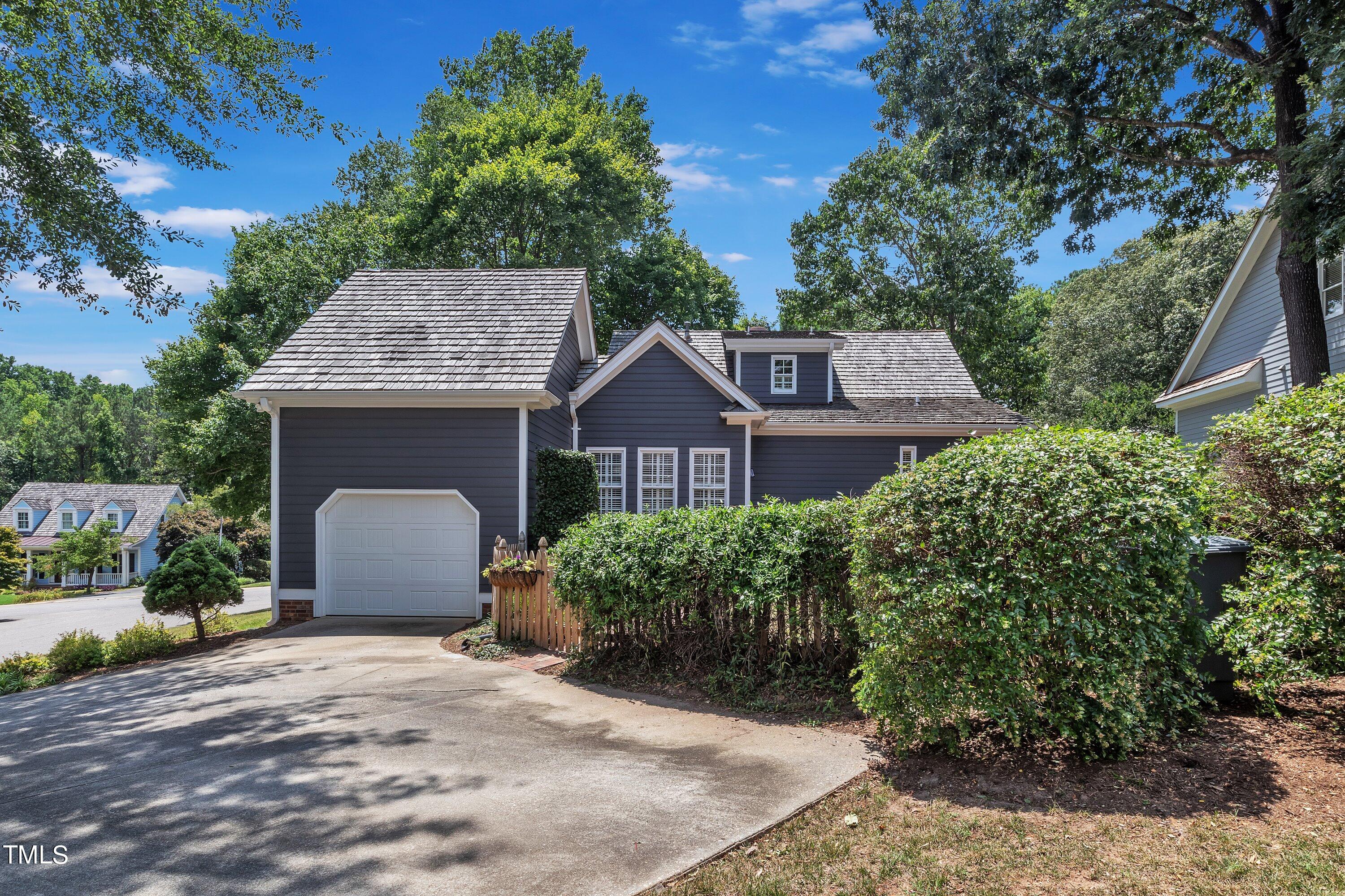 8500 Caldbeck Drive Raleigh, NC 27615 - Photo 36 of 37 a front view of a house with a garden