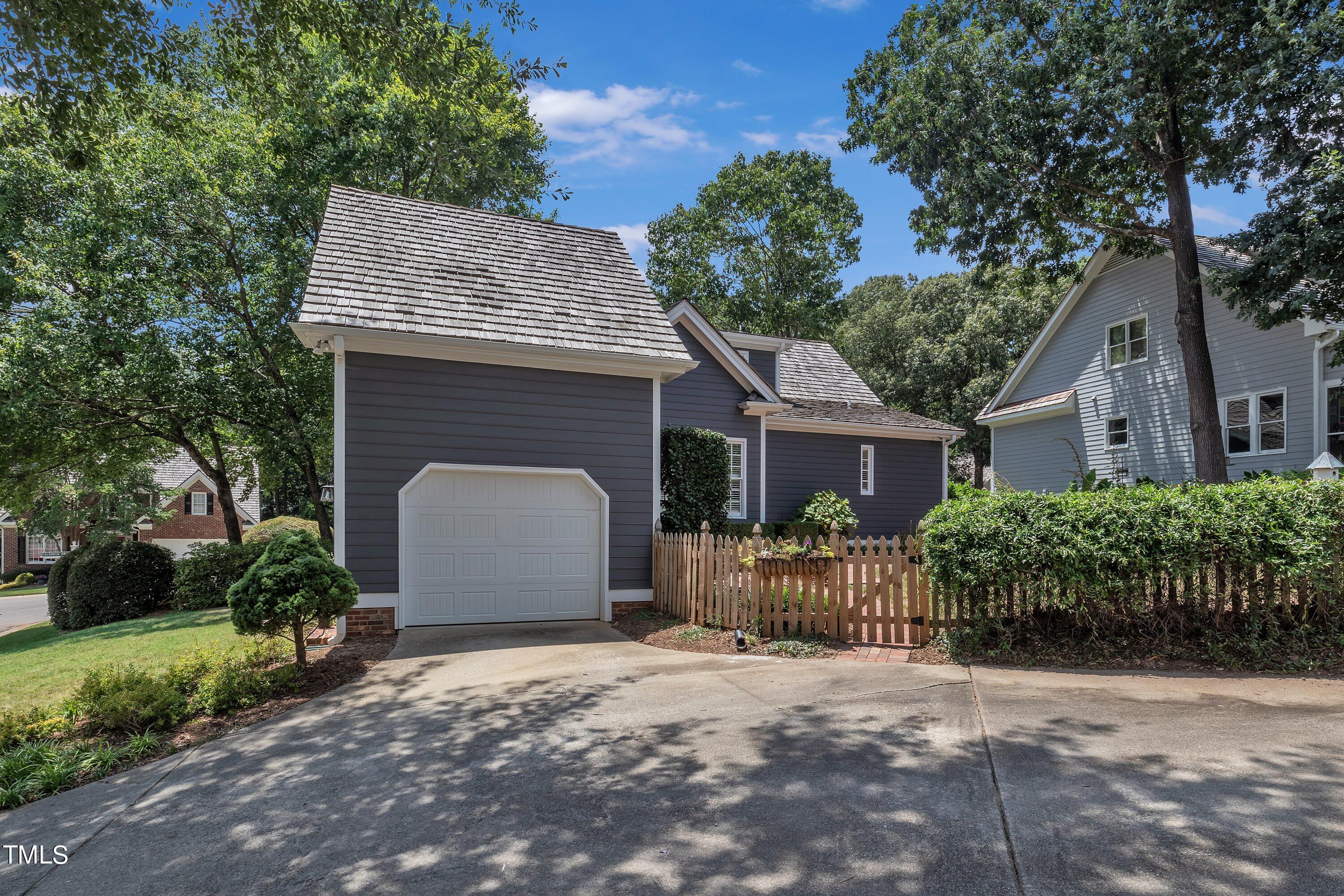 8500 Caldbeck Drive Raleigh, NC 27615 - Photo 37 of 37 a front view of house with a garden
