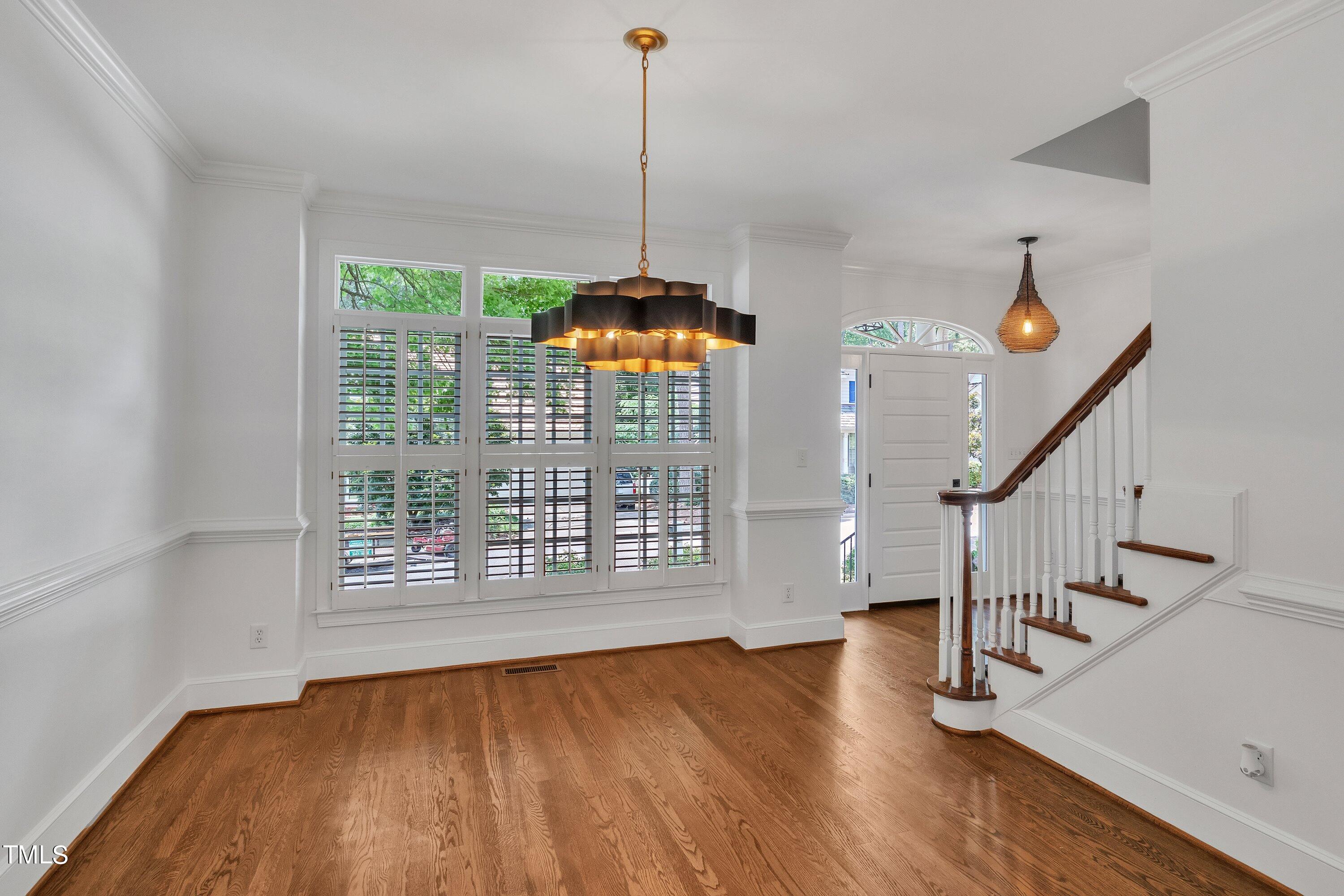 8500 Caldbeck Drive Raleigh, NC 27615 - Photo 6 of 37 a view of an empty room with wooden floor and a window