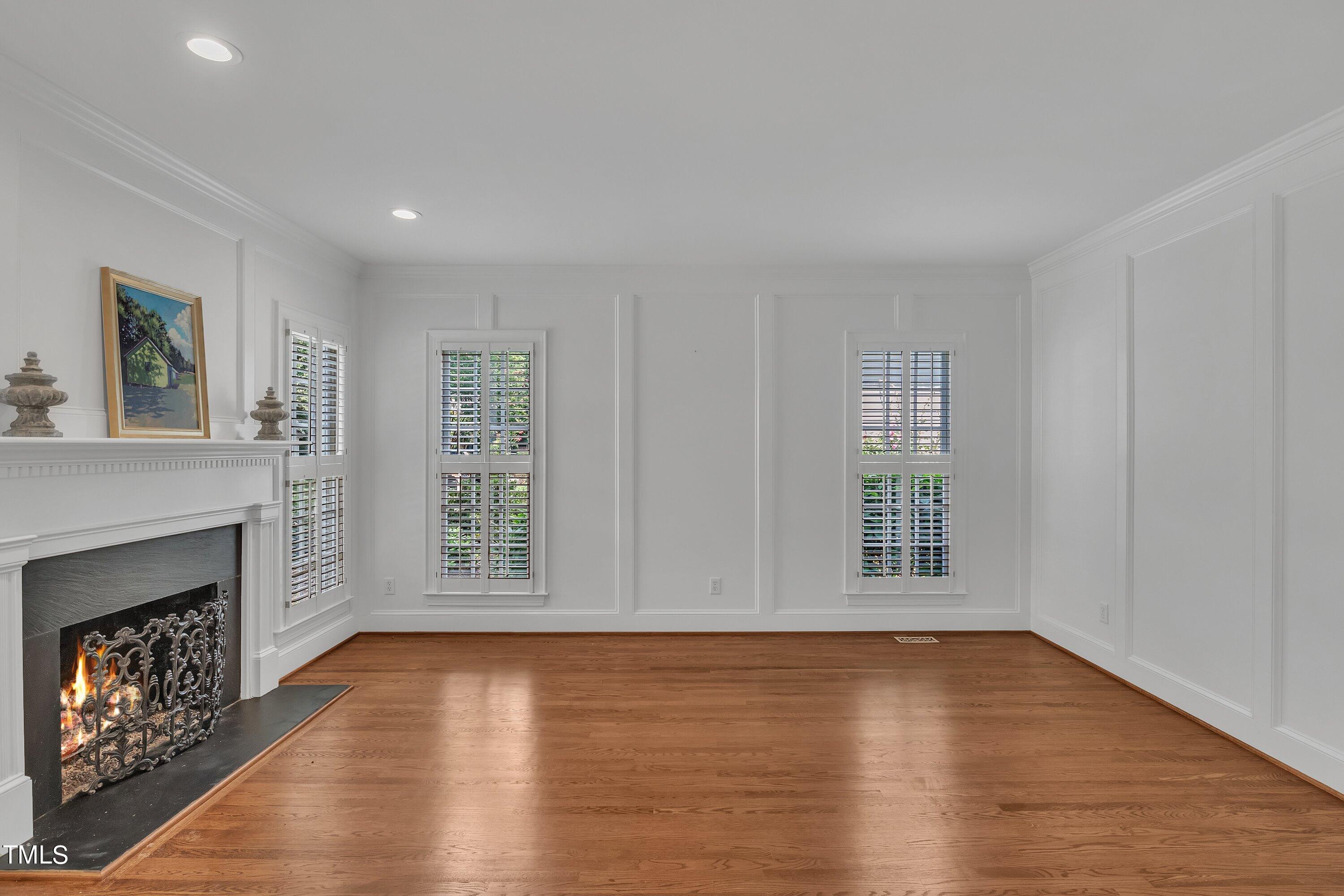 8500 Caldbeck Drive Raleigh, NC 27615 - Photo 7 of 37 a view of an empty room with wooden floor and a window