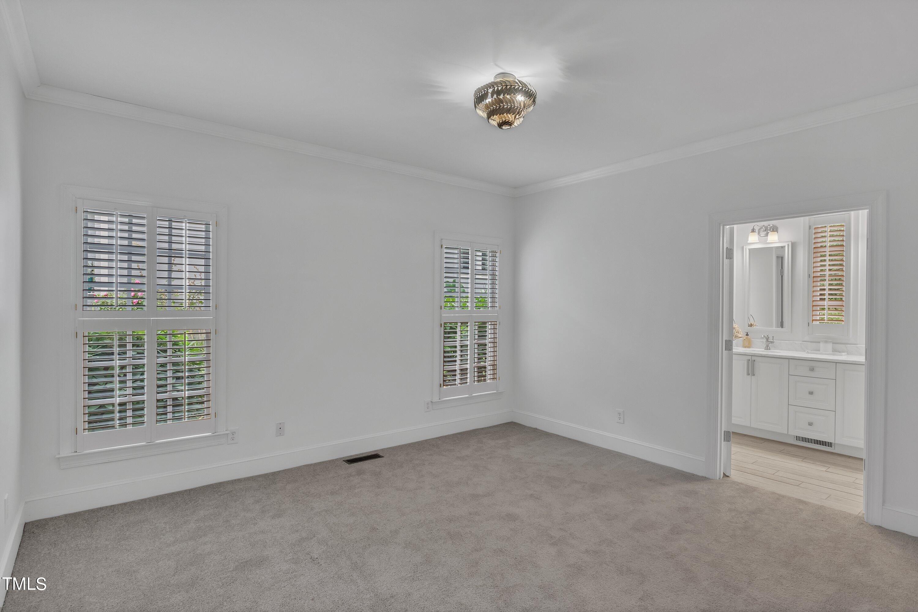 8500 Caldbeck Drive Raleigh, NC 27615 - Photo 10 of 37 an empty room with windows