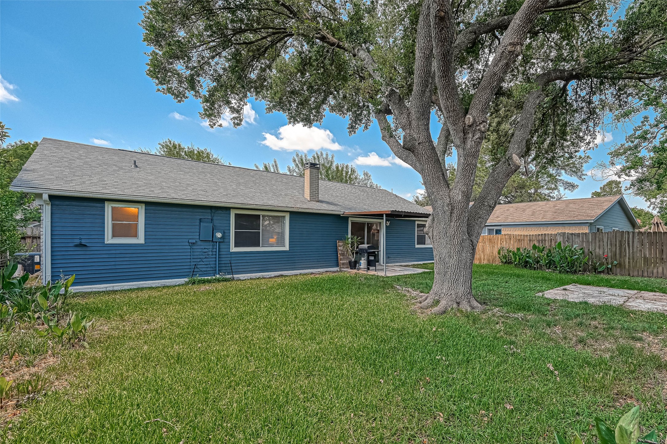 22622 John Rolfe Lane Katy, TX 77449 - Photo 20 of 21 a brick house with a large tree in front of a house