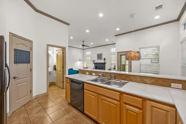 a kitchen with stainless steel appliances granite countertop a sink and a refrigerator