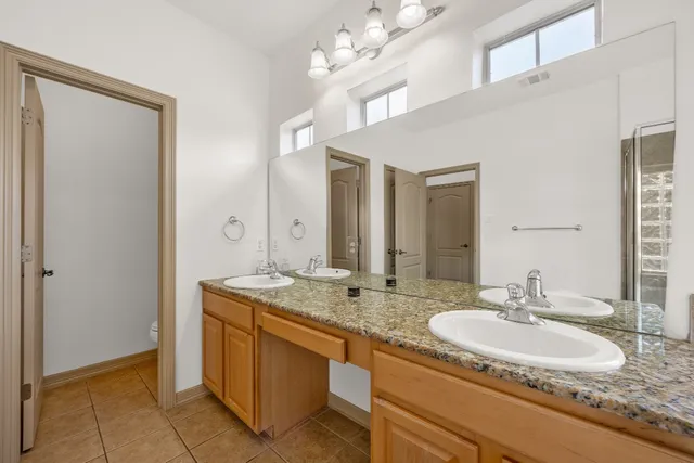 an empty room with fan and windows