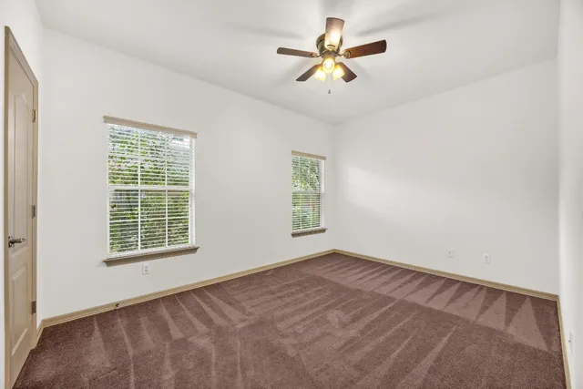 an empty room with windows and closet