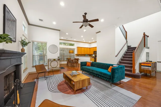 a living room with furniture fireplace and wooden floor