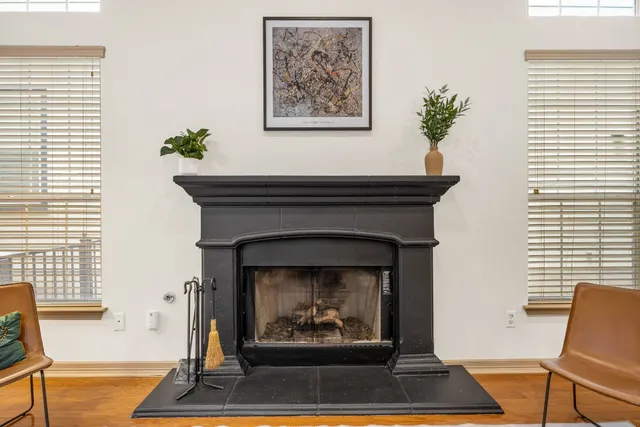 a living room with a fireplace and a rug