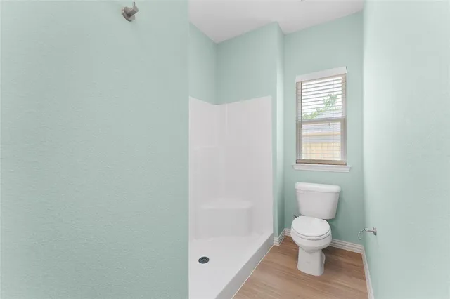 a white toilet sitting next to a bathroom sink