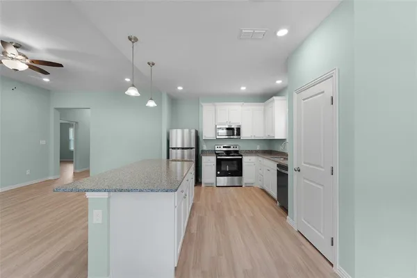 a view of kitchen with wooden floor