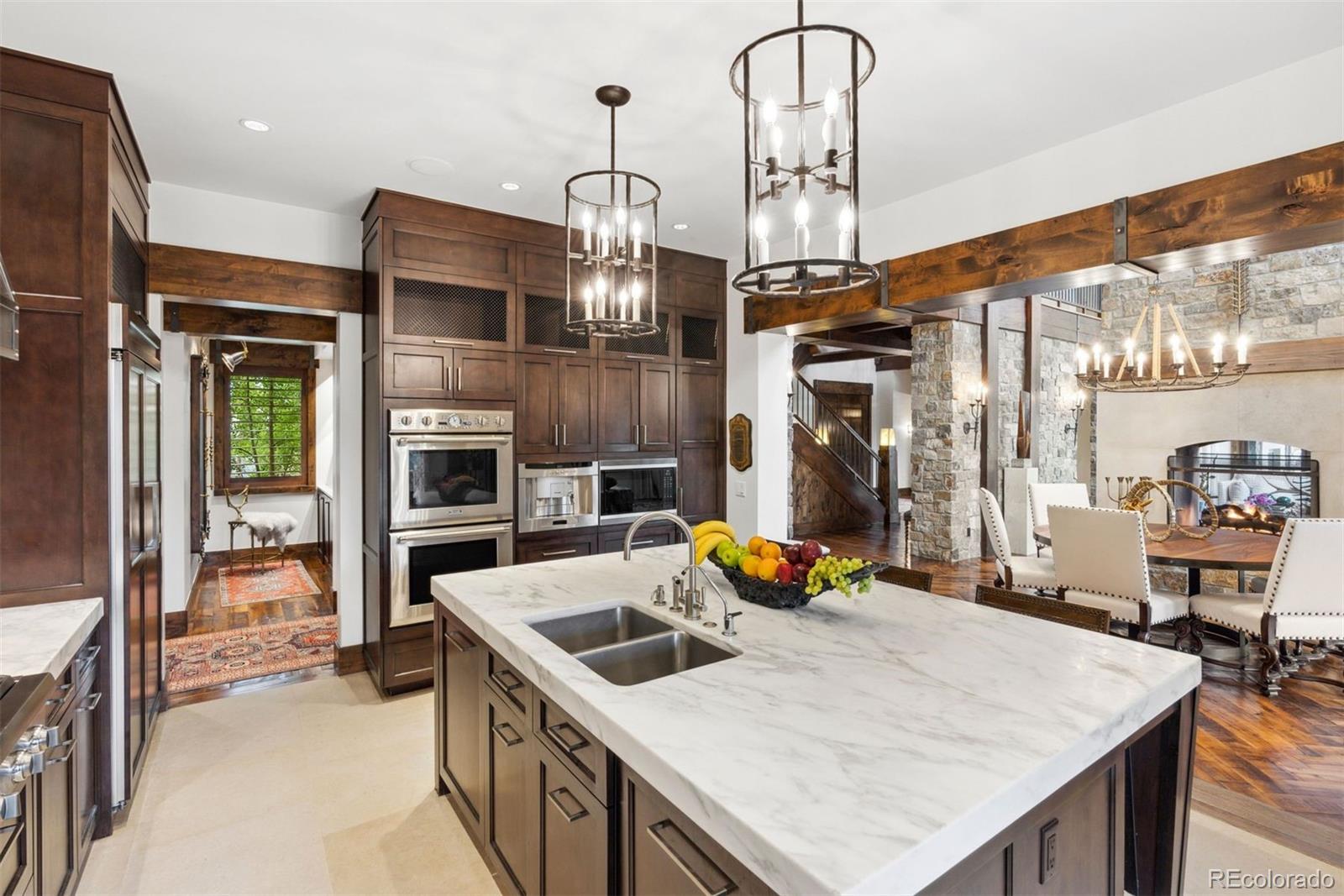 34650 Sleeping Fox Trail Evergreen, CO 80439 - Photo 12 of 49 a kitchen that has a lot of cabinets in it