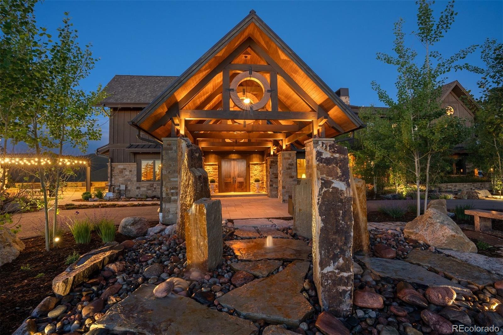 34650 Sleeping Fox Trail Evergreen, CO 80439 - Photo 2 of 49 a view of a brick house with a yard