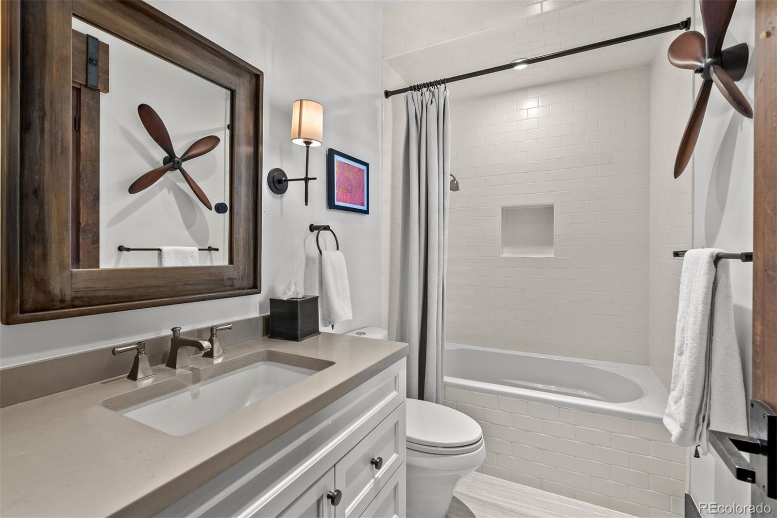 34650 Sleeping Fox Trail Evergreen, CO 80439 - Photo 23 of 49 a bathroom with a granite countertop sink toilet and shower